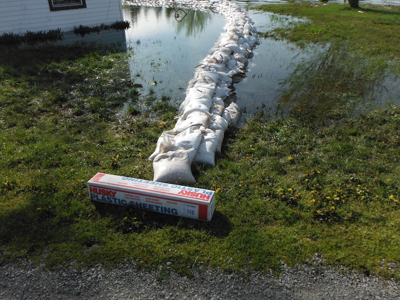 A U.S. Army Corps of Engineers Buffalo District Technical Assistance Field Team provided guidance on sandbag protection around a private residence in Lyme, New York. Plastic sheeting was deployed over the sand bag placement to mitigate water seepage. 

