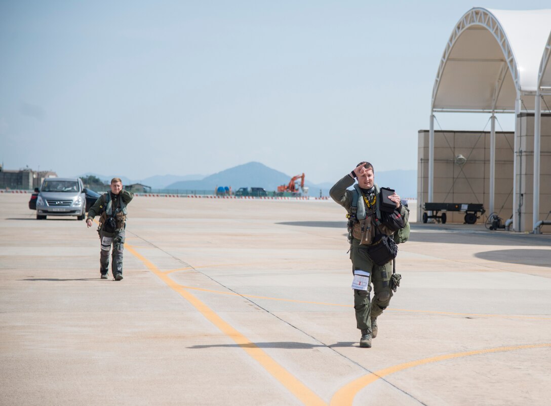 U.S. Air Force Capt. Jacob Impellizzeri, a 14th Fighter Squadron F-16 Fighting Falcon pilot, holds up the “wood” symbol while he walks toward his jet at Kunsan Air Base, Republic of Korea, May 16, 2017. Due to the flight line closure at Misawa Air Base, Japan, the 14th FS relocated to Kunsan, ensuring they keep up with mission requirements and readiness to maintain security and stability throughout the Indo-Asia-Pacific region. (U.S. Air Force photo by Senior Airman Brittany A. Chase)