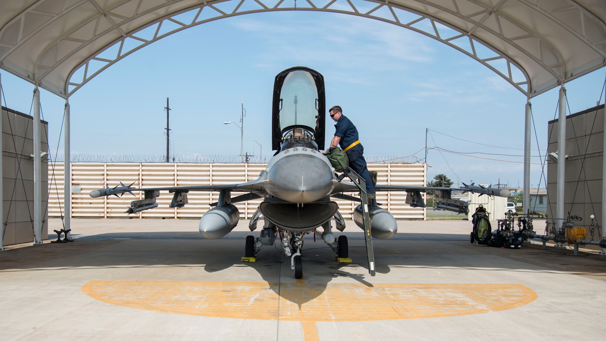 U.S. Air Force Airman 1st Class A.J. Kovacs, a 14th Aircraft Maintenance Unit crew chief, right, talks to Capt. Jacob Impellizzeri, left, a 14th Fighter Squadron F-16 Fighting Falcon pilot, prior to take-off at Kunsan Air Base, Republic of Korea, May 16, 2017. Team Misawa Airmen integrated with the 80th Fighter Squadrons daily operations to maintain readiness and proficiency and optimize uncommon training opportunities. (U.S. Air Force photo by Senior Airman Brittany A. Chase)