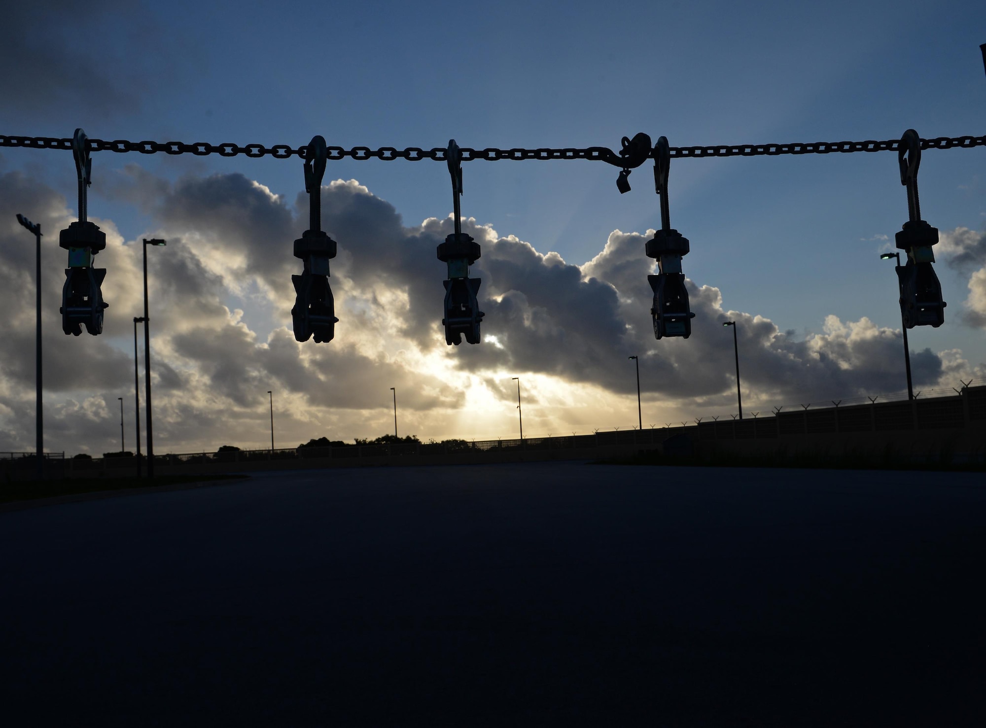 MB-1 devices hang on a chain to symbolize the number of fallen air transportation specialists from the past year May 19, 2017, at Andersen Air Force Base, Guam. Aerial porters, commonly referred to as Port Dawgs, congregate yearly to memorialize fallen teammates across the Air Force with a ceremony and formation run. (U.S. Air Force photo by Senior Airman Alexa Ann Henderson)