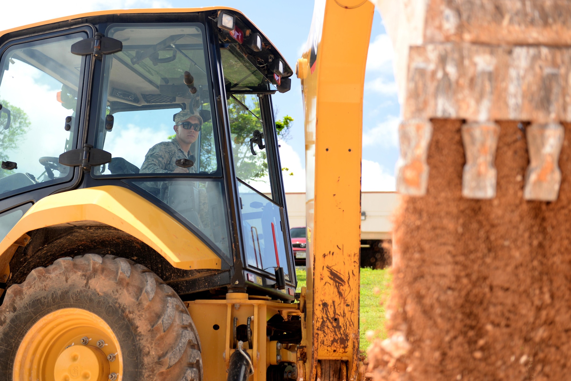 U.S. Air Force Airman 1st Class Austin Prendez, 36th Civil Engineering Squadron pavements and construction equipment journeyman, operates a front and backhoe loader May 2, 2017, at Andersen Air Force Base, Guam. The 36th CES is responsible for all facilities, infrastructure and two airfields with over 450 Airmen making it the largest squadron on Andersen AFB. (U.S. Air Force photo by Airman 1st Class Gerald R. Willis)