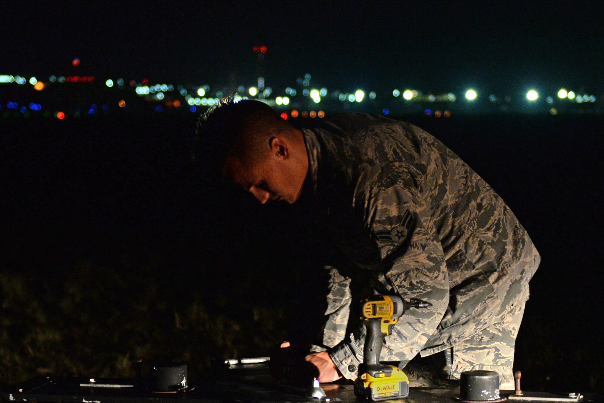 U.S. Air Force Airman 1st Class Ryan Muller, 36th Civil Engineering Squadron electrician, changes a light on the flightline May 16, 2017, at Andersen Air Force Base, Guam. The 36th CES is responsible for all facilities, infrastructure and two airfields with over 450 Airmen making it the largest squadron on Andersen AFB. (U.S. Air Force photo by Airman 1st Class Gerald R. Willis)