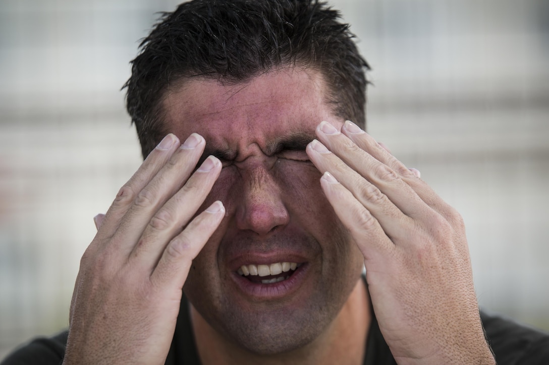 Capt. Justin Lenio wipes water from his eyes after finishing a portion of the U.S. Marine Corps Combatant Divers Course, on Camp Schwab, Okinawa, Japan, May 11, 2017. After diving, the students sit for 10 minutes to ensure they aren’t at risk from potential hazards involved with the pressure underwater. The USMC Combatant Divers Course is eight weeks and combines lectures, demonstrations and practical application of circuit diving, diving physics, and medical aid. Lenio, from St. Augustine, Florida, is a reconnaissance Marine with 3rd Reconnaissance Battalion, 3rd Marine Division, III Marine Expeditionary Force. (U.S. Marine Corps photo by Sgt. Isaac Ibarra)