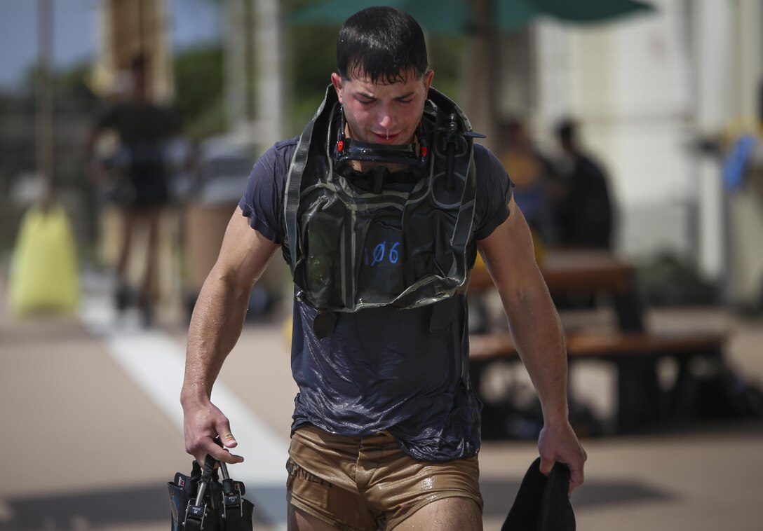 Sgt. William Wagner emerges from the pool after finishing a portion of the U.S. Marine Corps Combatant Divers Course, on Camp Schwab, Okinawa, Japan, May 11, 2017. A mobile training team from Navy Diving and Salvage Training Center, Panama City, Florida, conducted the training. The USMC Combatant Divers Course is eight weeks and combines lectures, demonstrations and practical application of circuit diving, diving physics, and medical aid. Wagner, from Dallas, Texas, is a reconnaissance Marine with 3rd Reconnaissance Battalion, 3rd Marine Division, III Marine Expeditionary Force.(U.S. Marine Corp photo by Sgt. Isaac Ibarra)