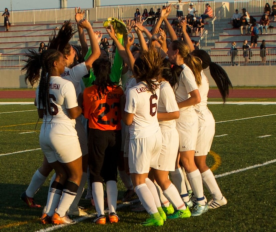 The Matthew C. Perry’s Lady Samurai soccer team gather around and jump in excitement after winning the 2017 Girls Division II Soccer Tournament at Marine Corps Air Station Iwakuni, Japan, May 18, 2017. International and Department of Defense Education Activity high school teams from all over Japan made up the four-day, 32-game tournament with M.C. Perry winning the championship against International School of the Sacred Heart 2-0. (U.S. Marine Corps photo by Pfc. Stephen Campbell)