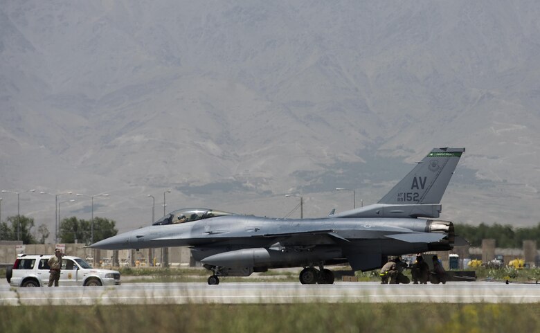 Airmen remove a cable from an F-16 Fighting Falcon, assigned to the 555th Expeditionary Fighter Squadron, at Bagram Airfield, Afghanistan, May 19, 2017. The cable is part of the mobile aircraft arresting system, which is used to rapidly decelerate an aircraft. (U.S. Air Force photo by Staff Sgt. Benjamin Gonsier)