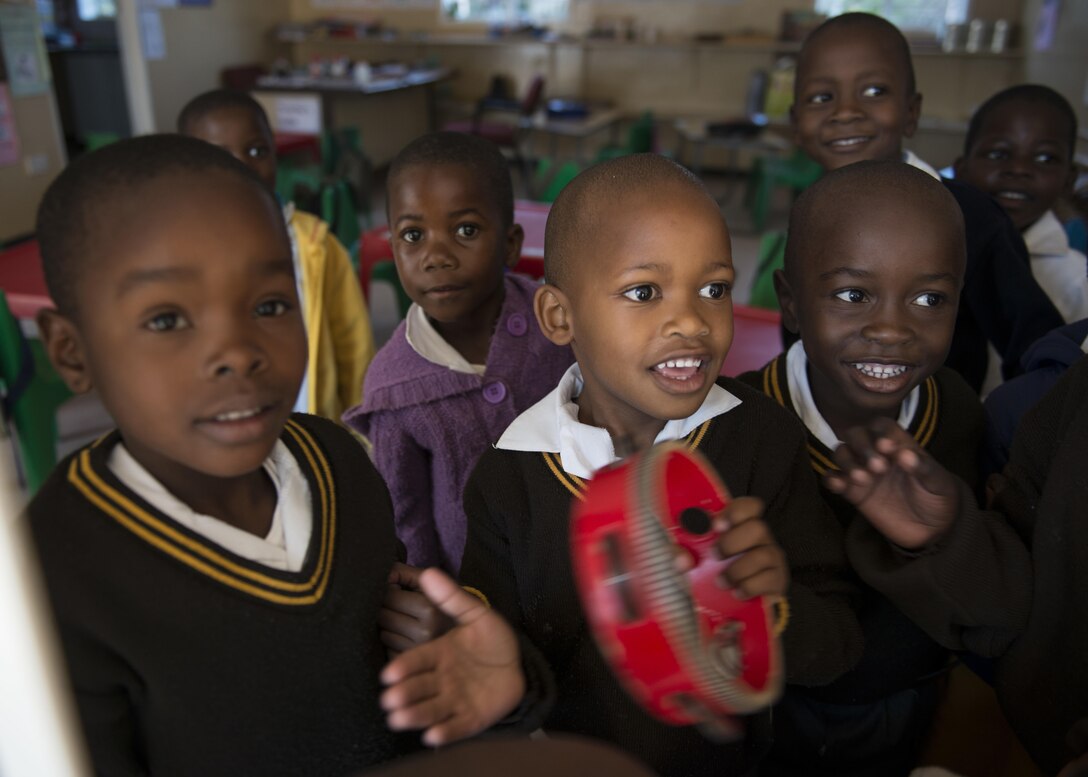 Students of the Kachikau Primary School play with a tambourine during a visit by the U.S. Air Forces in Europe “Ambassadors Combo” performance Band and the Botswana Defence Force Band in Kachikau, Botswana on May 17, 2017. While supporting the 2017 African Air Chiefs Symposium, the bands partnered together to perform concerts at four primary and secondary schools in northern Botswana to inspire the students through the universal language of music. The U.S. and Botswana are co-host of this year’s symposium. (U.S. Air Force photo by Staff Sgt. Krystal Ardrey)