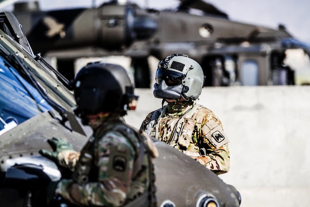 Army crew chiefs prepare a UH-60 Black Hawk helicopter for a mission at Operating Base Fenty, Jalalabad, Afghanistan, May 17, 2017. The crew chiefs are the 7th Infantry Division’s Task Force Tigershark, 16th Combat Aviation Brigade. Army photo by Capt. Brian Harris