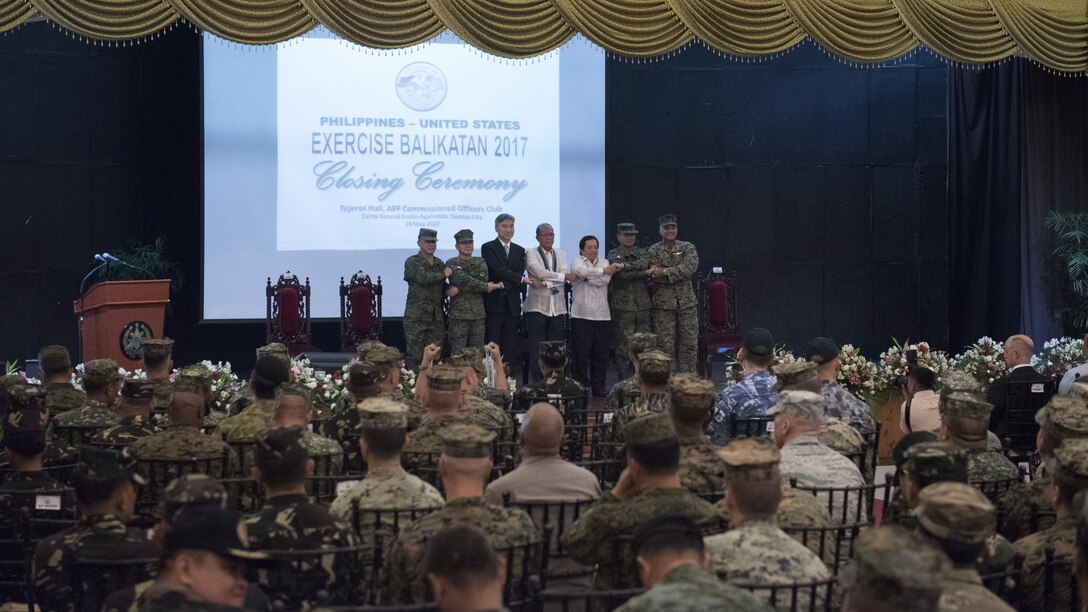 Armed Forces of the Philippines Maj. Gen. Herminigildo Aquino, left, AFP Gen. Eduardo M. Año, the Honorable Ambassador Sung Y. Kim, Secretary Delfin N. Lorenzana, Under Secretary Ariel Y. Abadilla, AFP Lt. Gen. Oscar T. Lactao, and U.S. Marine Brig. Gen. Brian Cavanaugh stand “shoulder-to-shoulder” and shake hands during the Balikatan 2017 closing ceremony at Camp Aguinaldo, Quezon City, May 19, 2017. Aquino is the Philippine assistance exercise director. Año is the Chief of Staff of the AFP. Kim is the U.S. Ambassador to the Philippines. Lorenzana is the Philippine Secretary of National Defense. Abadilla is the Philippine Undersecretary for Civilian Security and Consular Concerns. Lactao is the Philippine exercise director for Balikatan. Cavanaugh is the deputy commander of Marine Corps Forces, Pacific. Balikatan is an annual U.S.-Philippine bilateral military exercise focused on a variety of missions, including humanitarian assistance and disaster relief, counterterrorism, and other combined military operations. 