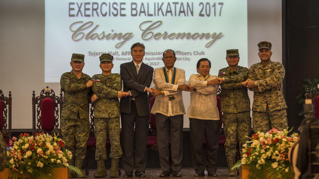 Armed Forces of the Philippines Maj. Gen. Herminigildo Aquino, left, AFP Gen. Eduardo M. Año, the Honorable Ambassador Sung Y. Kim, Secretary Delfin N. Lorenzana, Under Secretary Ariel Y. Abadilla, AFP Lt. Gen. Oscar T. Lactao, and U.S. Marine Brig. Gen. Brian Cavanaugh stand “shoulder-to-shoulder” and shake hands during the Balikatan 2017 closing ceremony at Camp Aguinaldo, Quezon City, May 19, 2017. Aquino is the Philippine assistance exercise director. Año is the Chief of Staff of the AFP. Kim is the U.S. Ambassador to the Philippines. Lorenzana is the Philippine Secretary of National Defense. Abadilla is the Philippine Undersecretary for Civilian Security and Consular Concerns. Lactao is the Philippine exercise director for Balikatan. Cavanaugh is the deputy commander of Marine Corps Forces, Pacific. Balikatan is an annual U.S.-Philippine bilateral military exercise focused on a variety of missions, including humanitarian assistance and disaster relief, counterterrorism, and other combined military operations. (