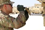 Cpt. Bao Le, a USARCENT battle captain, opened an expanding van via hand crank during set up of the contingent command post tactical operations center during the May 4th set up for Exercise Eager Lion in Jordan. (U.S. Army Photo by Cadet James Mason)