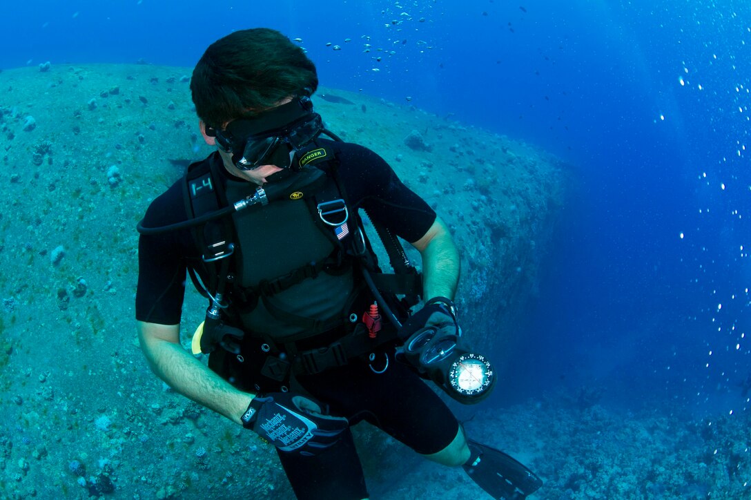 Lt. j.g. Stephen Patane, assigned to Commander, Task Group 56.1, EOD Mobile Unit 12, checks his depth gauge during a training dive for Exercise Eager Lion 2017. Eager Lion is an annual U.S. Central Command exercise in Jordan designed to strengthen military-to- military relationships between the U.S., Jordan and other international partners. This year's iteration is comprised of about 7,200 military personnel from more than 20 nations that will respond to scenarios involving border security, command and control, cyber defense and battlespace management. (U.S. Navy Combat Camera photo by Mass Communication Specialist 2nd Class Austin L. Simmons)