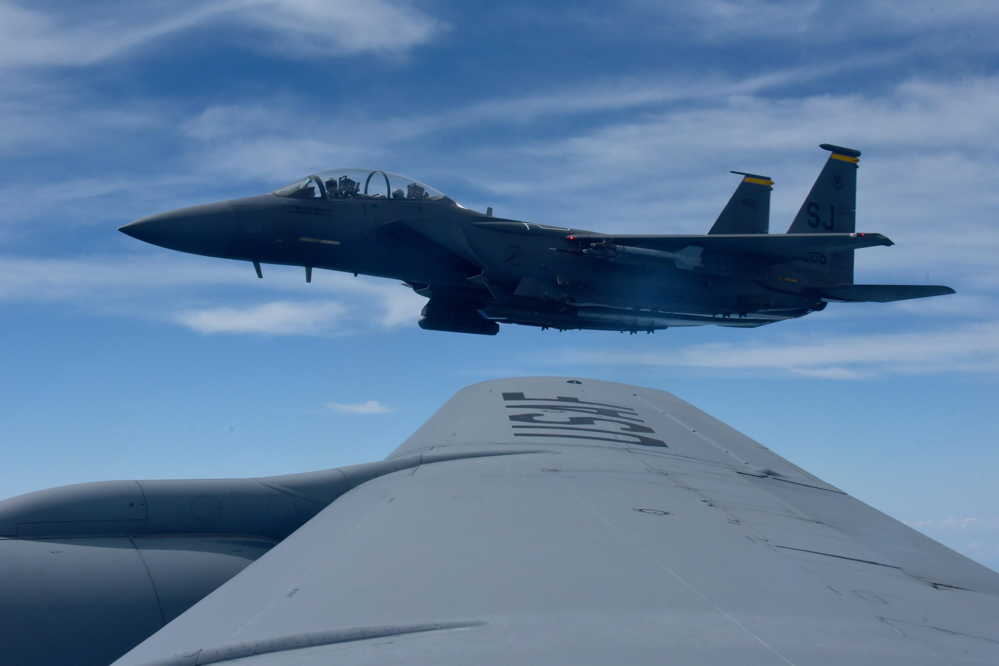 A 336th Fighter Squadron F-15E Strike Eagle flies near a KC-135R Stratotanker, May 18, 2017, in the skies over Seymour Johnson Air Force Base, North Carolina. The Wings Over Wayne Air Show will feature Strike Eagle formation flights during the two-day free event, May 20-21, 2017. (U.S. Air Force photo by Airman 1st Class Kenneth Boyton)