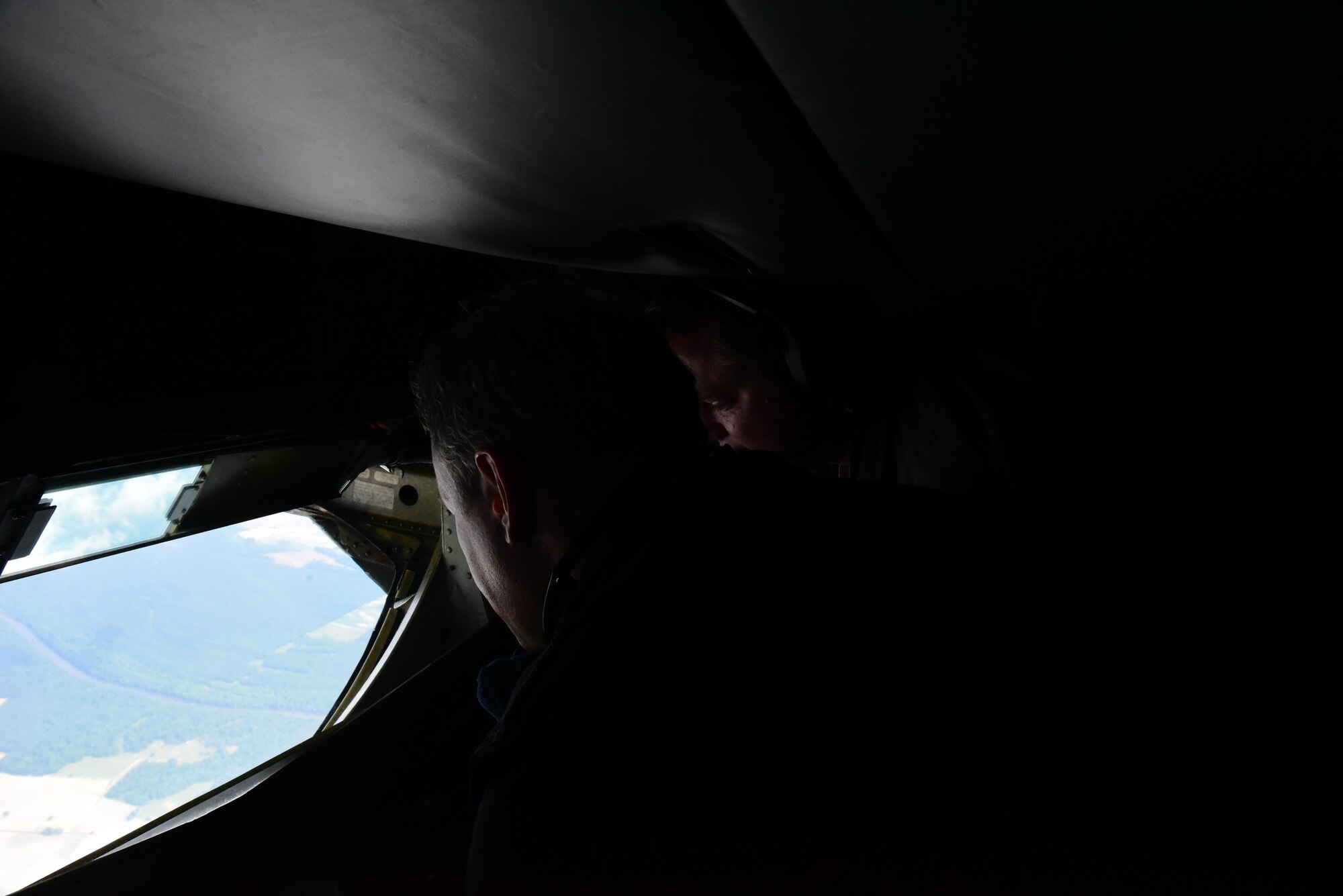 Dan Forest, North Carolina Lt. Governor, and Staff Sgt. Dan Frost, 77th Air Refueling Squadron instructor boom operator, look out of a boom operator window, May 18, 2017, in the skies over Seymour Johnson Air Force Base, North Carolina. Seymour Johnson AFB is home to the F-15E Strike Eagle and the KC-135R Stratotanker. (U.S. Air Force photo by Airman 1st Class Kenneth Boyton)