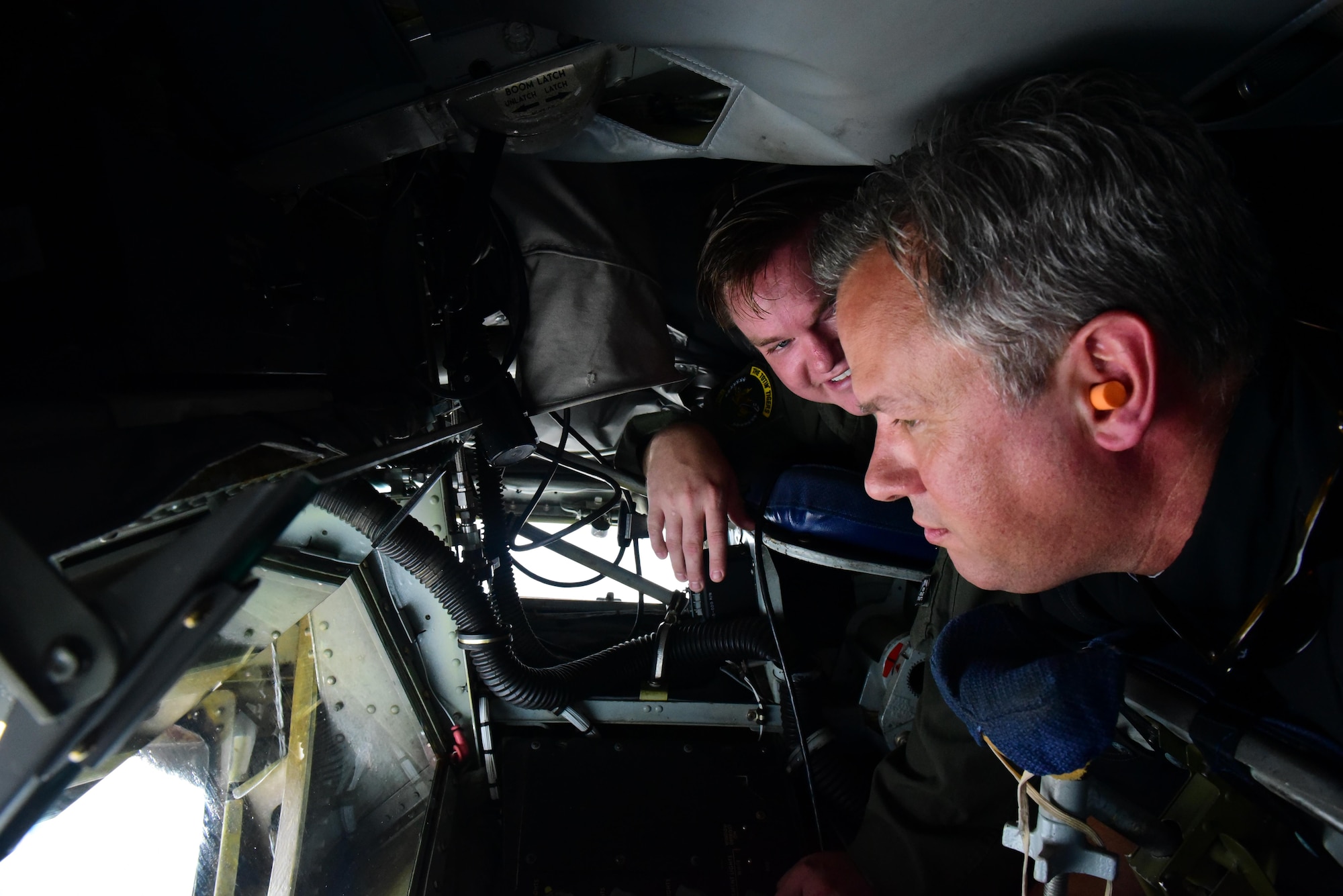 Dan Forest, North Carolina Lt. Governor, and Staff Sgt. Dan Frost, 77th Air Refueling Squadron instructor boom operator, look out of a boom operator window, May 18, 2017, in the skies over Seymour Johnson Air Force Base, North Carolina. Forest and other civic leaders received a KC-135R Stratotanker incentive flight two days before the Wings Over Wayne Air Show. (U.S. Air Force photo by Airman 1st Class Kenneth Boyton)