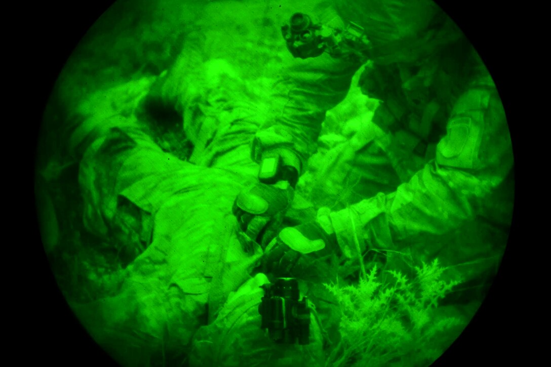 As seen through a night-vision lens, a U.S. soldier provides medical aid to a mock casualty during Bayonet-Minotaur Exercise 2017 in Thessaloniki, Greece, May 17, 2017. Army photo by Graigg Faggionato