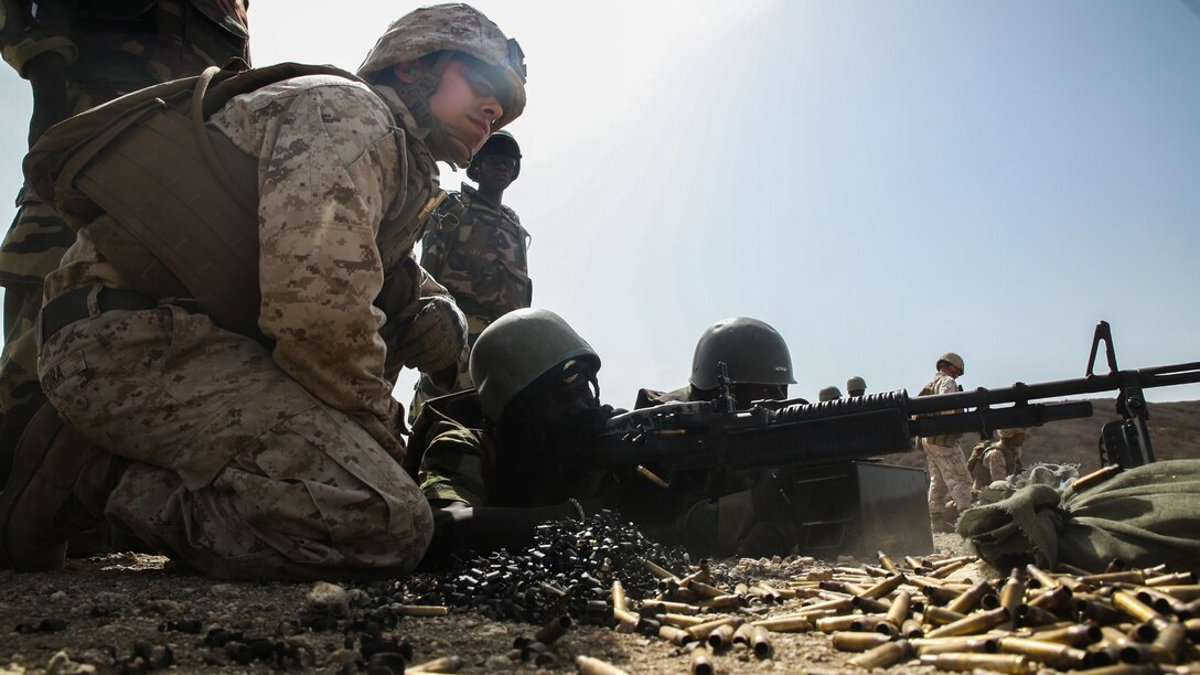 Cpl. Robert Piedra, a rifleman with Special Purpose Marine Air-Ground Task Force – Crisis Response – Africa, coaches a member of Senegal’s Compagnie Fusilier de Marin Commando fire the M60 Machinegun during a known distance range at Thies, Senegal, May 2, 2017.  Marines with SPMAGTF-CR-AF and the COFUMACO conducted a four-week training exercise that included advanced combat firing techniques, a machine gun range and a live-fire platoon attack range.  
