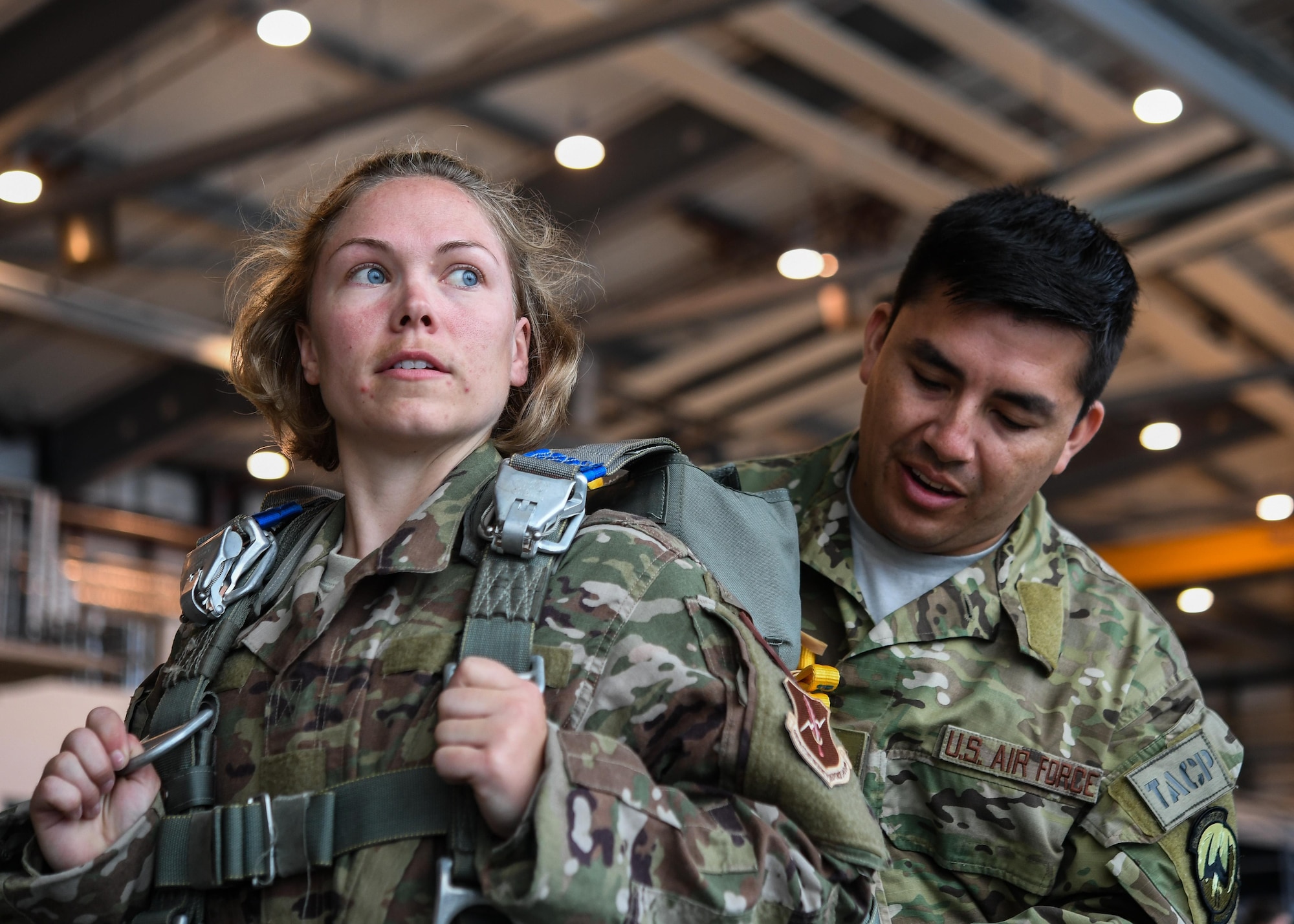 Tech Sgt. Cortney Velez, 435th Contingency Response Support Squadron independent duty medical technician and Master Sgt. David Galindo, 2nd Air Support Operations Squadron operations superintendent, prepare gear prior to a personnel drop over Alzey, Germany, May 12, 2017. Velez completed her first jump with the 435 CRG and is U.S. Air Forces in Europe’s first female airborne IDMT. (U.S. Air Force by Staff Sgt. Nesha Humes)