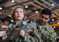 Tech Sgt. Cortney Velez, 435th Contingency Response Support Squadron independent duty medical technician and Master Sgt. David Galindo, 2nd Air Support Operations Squadron operations superintendent, prepare gear prior to a personnel drop over Alzey, Germany, May 12, 2017. Velez completed her first jump with the 435 CRG and is U.S. Air Forces in Europe’s first female airborne IDMT. (U.S. Air Force by Staff Sgt. Nesha Humes)