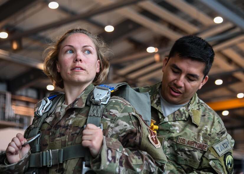 Tech Sgt. Cortney Velez, 435th Contingency Response Support Squadron independent duty medical technician and Master Sgt. David Galindo, 2nd Air Support Operations Squadron operations superintendent, prepare gear prior to a personnel drop over Alzey, Germany, May 12, 2017. Velez completed her first jump with the 435 CRG and is U.S. Air Forces in Europe’s first female airborne IDMT. (U.S. Air Force by Staff Sgt. Nesha Humes)