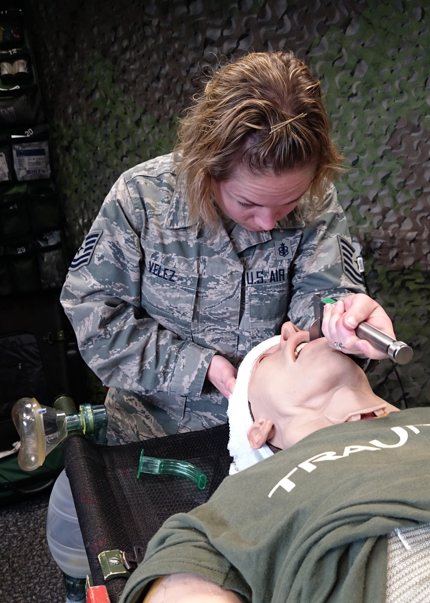 Tech Sgt. Cortney Velez, 435th Contingency Response Support Squadron independent duty medical technician, simulates opening an airway at Ramstein Air Base, Germany, May 17, 2017. Velez is U.S. Air Forces in Europe’s first female airborne IDMT. (U.S. Air Force photo by Staff Sgt. Nesha Humes)