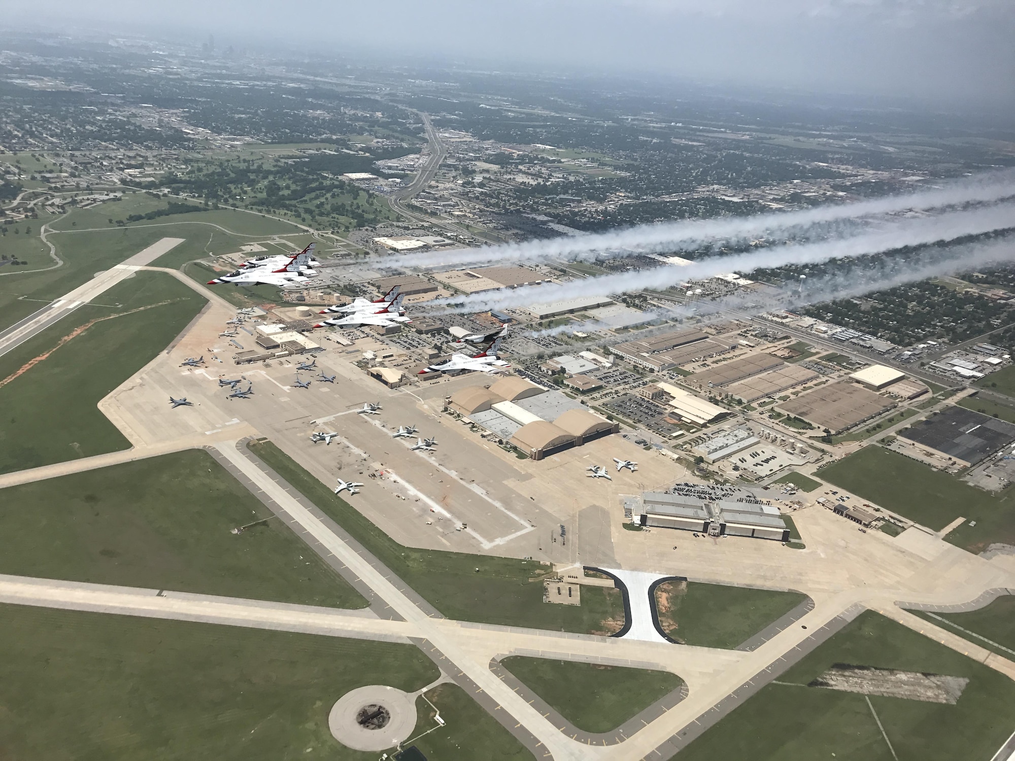 The U.S. Air Force Thunderbirds fly over Tinker Air Force Base, Okla., May 18, 2017, before landing for the Tinker 75th Anniversary Start Spangled Salute air show. The event, scheduled for May 20-21, is free and open to the public. (U.S. Air Force photo/Tech. Sgt. Lauren Gleason/Released)