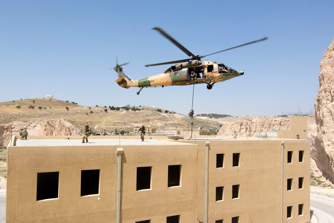 U.S. Air Force airmen fast-rope from a Jordanian UH-60 helicopter during training at the King Abdullah II Special Operations Training Center during Eager Lion 2017 in Amman, Jordan, May 11, 2017. Navy photo by Petty Officer 2nd Class Christopher Lange