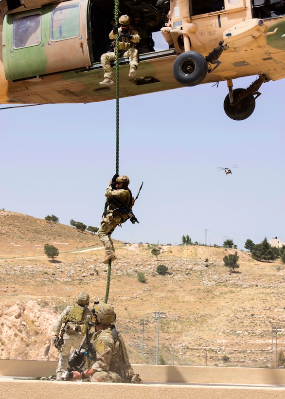 U.S. airmen fast-rope from a Jordanian UH-60 helicopter during training at the King Abdullah II Special Operations Training Center during Eager Lion 2017 in Amman, Jordan, May 11, 2017. Navy photo by Petty Officer 2nd Class Christopher Lange