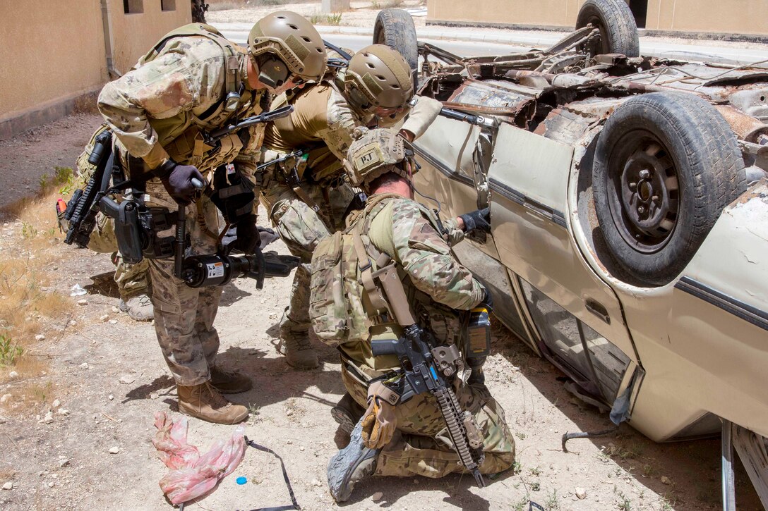 A U.S. airman and Italian Special Operations Wing members attempt to gain access to a vehicle during a combat search and rescue exercise at the King Abdullah II Special Operations Training Center, part of Eager Lion 2017 in Amman, Jordan, May 11, 2017. Navy photo by Petty Officer 2nd Class Christopher Lange
