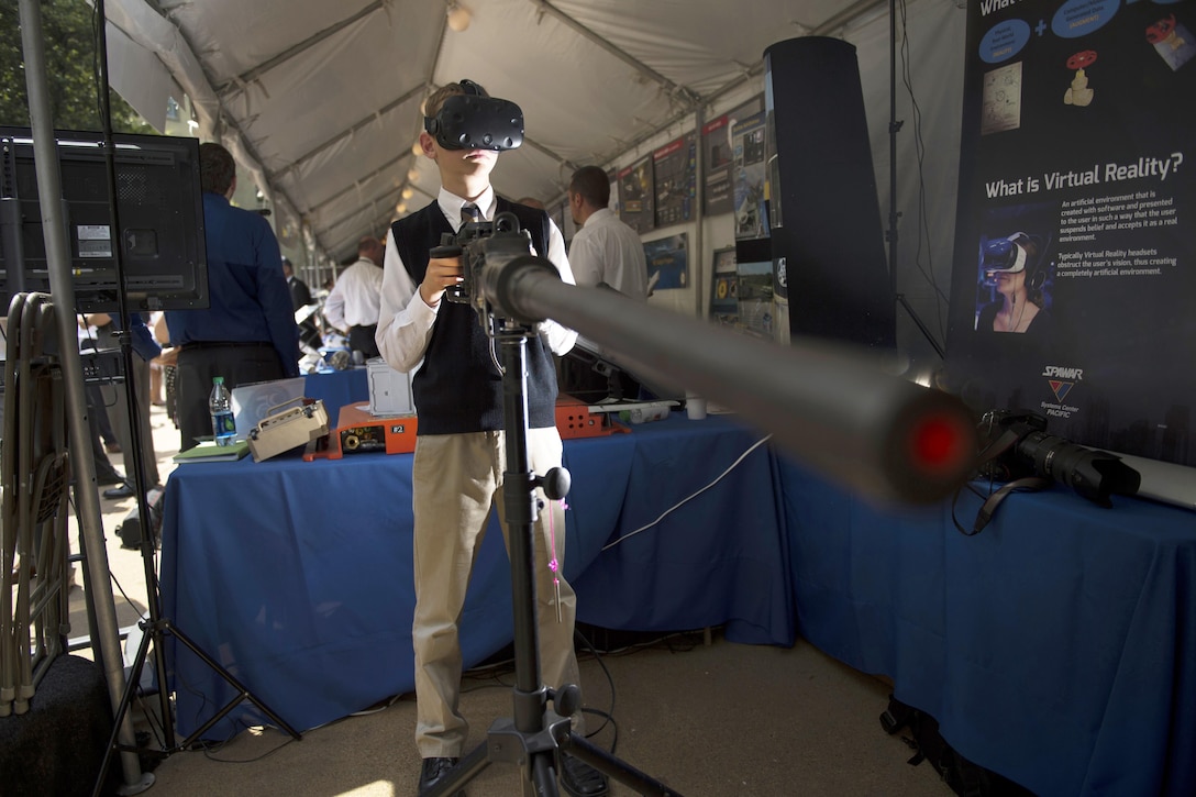 A student experiences firing a Navy machine gun in virtual reality during DoD Lab Day at the Pentagon, May 18, 2017. DoD photo by EJ Hersom)