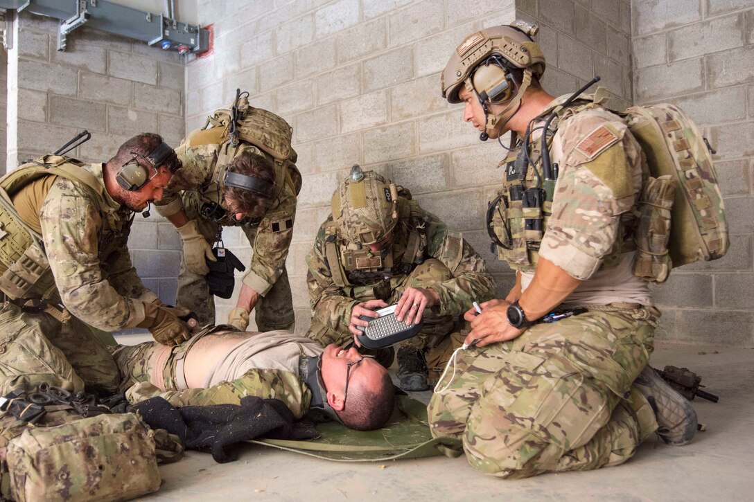 U.S. airmen and Italian Special Operations Wing members provide medical aid to a mock casualty during a combat search and rescue exercise at the King Abdullah II Special Operations Training Center, part of Eager Lion 2017 in Amman, Jordan, May 11, 2017. Navy photo by Petty Officer 2nd Class Christopher Lange