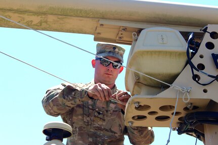 Spc. Ryan Mcelaney, assigned to the 338th Transportation Detachment (Harbormaster), works on the Harbormaster Command and Control Center at Joint Expeditionary Base Little Creek-Fort Story, Virginia Beach, Va. May 14, 2017. He traveled to the area along with nearly 450 U.S. Army Reserve Soldiers for Big Logistics Over the Shore (Big LOTS) East 2017, a U.S. Army Reserve exercise that provides hands-on training for boat units, terminal battalions, and deployment support command units to sharpen critical tasks that support bare beach operations.(U.S. Army Reserve Photo by 1st Sgt. Angele Ringo)