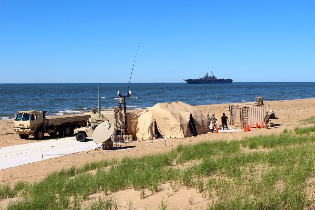 The Harbormaster Command and Control Center (HCCC) sits on the beach at Joint Expeditionary Base Fort Story, Va. May 15, 2017.  Soldiers from the 338th Transportation Detachment (Harbormaster) assembled the system in preparation for Big Logistics Over the Shore (Big LOTS) East 2017, a U.S. Army Reserve exercise that provides hands-on training for boat units, terminal battalions, and deployment support command units to sharpen critical tasks that support bare beach operations. The HCCC is a communications hub that provides a complete picture of beach operations and tracks supplies moving on and off vessels. (U.S. Army Reserve Photo by 1st Sgt. Angele Ringo)