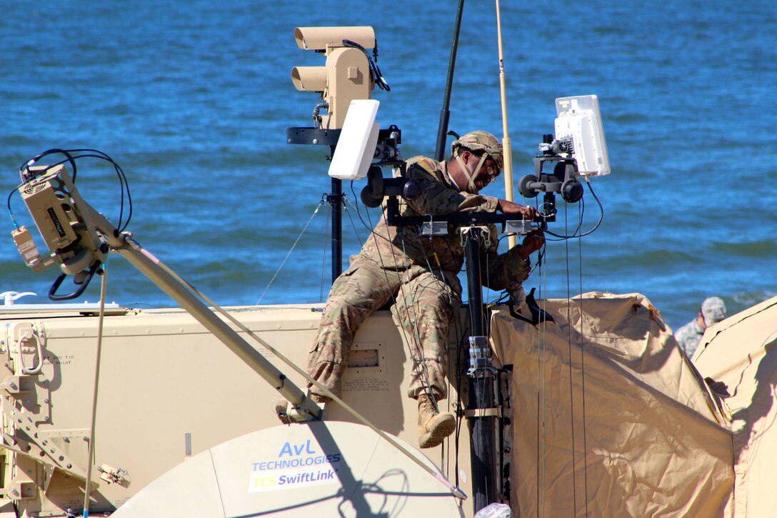 Staff Sgt. Yohannes Page, assigned to the 338th Transportation Detachment (Harbormaster) , makes an adjustment on a sensor atop a component of the Harbormaster Command and Control Center at Joint Expeditionary Base Fort Story May 15, 2017. Page, who is a watercraft operator was among nearly 450 U.S. Army Reserve Soldiers participating in Big Logistics Over the Shore East 2017, a U.S. Army Reserve exercise that provides hands-on training for boat units, terminal battalions, and deployment support command units to sharpen critical tasks that support bare beach operations. (U.S. Army Reserve Photo by 1st Sgt. Angele Ringo)