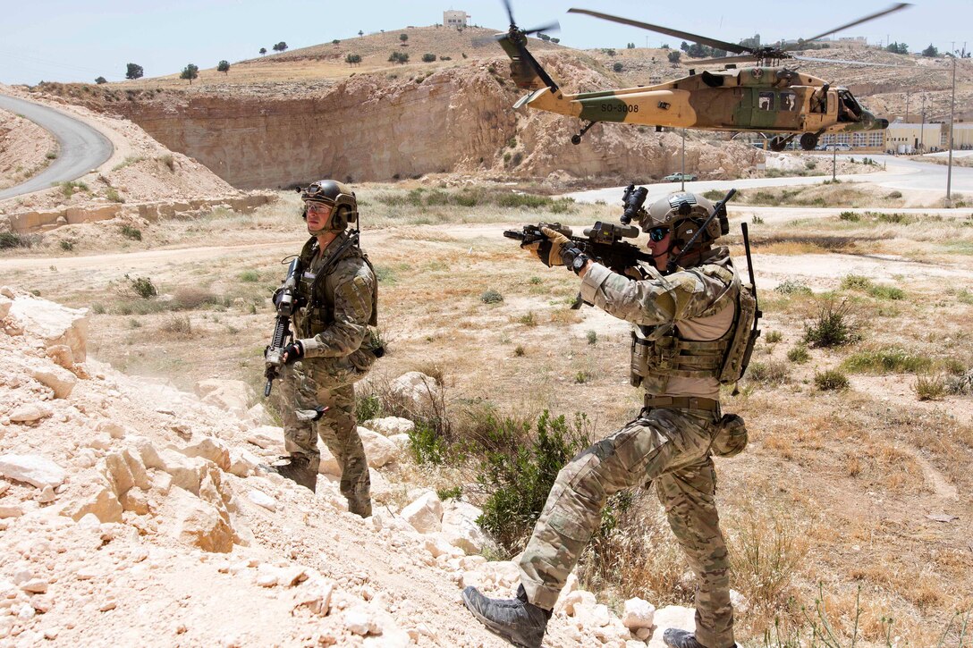 U.S. airmen provide security at a landing zone while a Jordanian UH-60 helicopter prepares to land during a combat search and rescue exercise at the King Abdullah II Special Operations Training Center, part of Eager Lion 2017 in Amman, Jordan, May 11, 2017. Navy photo by Petty Officer 2nd Class Christopher Lange
