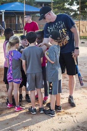 Cpl. Jamie Brooks closes out his youth t-ball practice
with a team huddle aboard Laurel Bay, May 14. Brooks
has been coaching youth sports teams for the past two
years. “I grew up playing sports and I think it’s important to give back,” said Brooks. “I want the kids I teach to feel successful at their sports and to see measurable improvement. I also know that I am teaching them things that I learned while playing sports as a kid; things like team work and self-discipline.” Brooks is an administrative specialist with Headquarters and Headquarters Squadron.