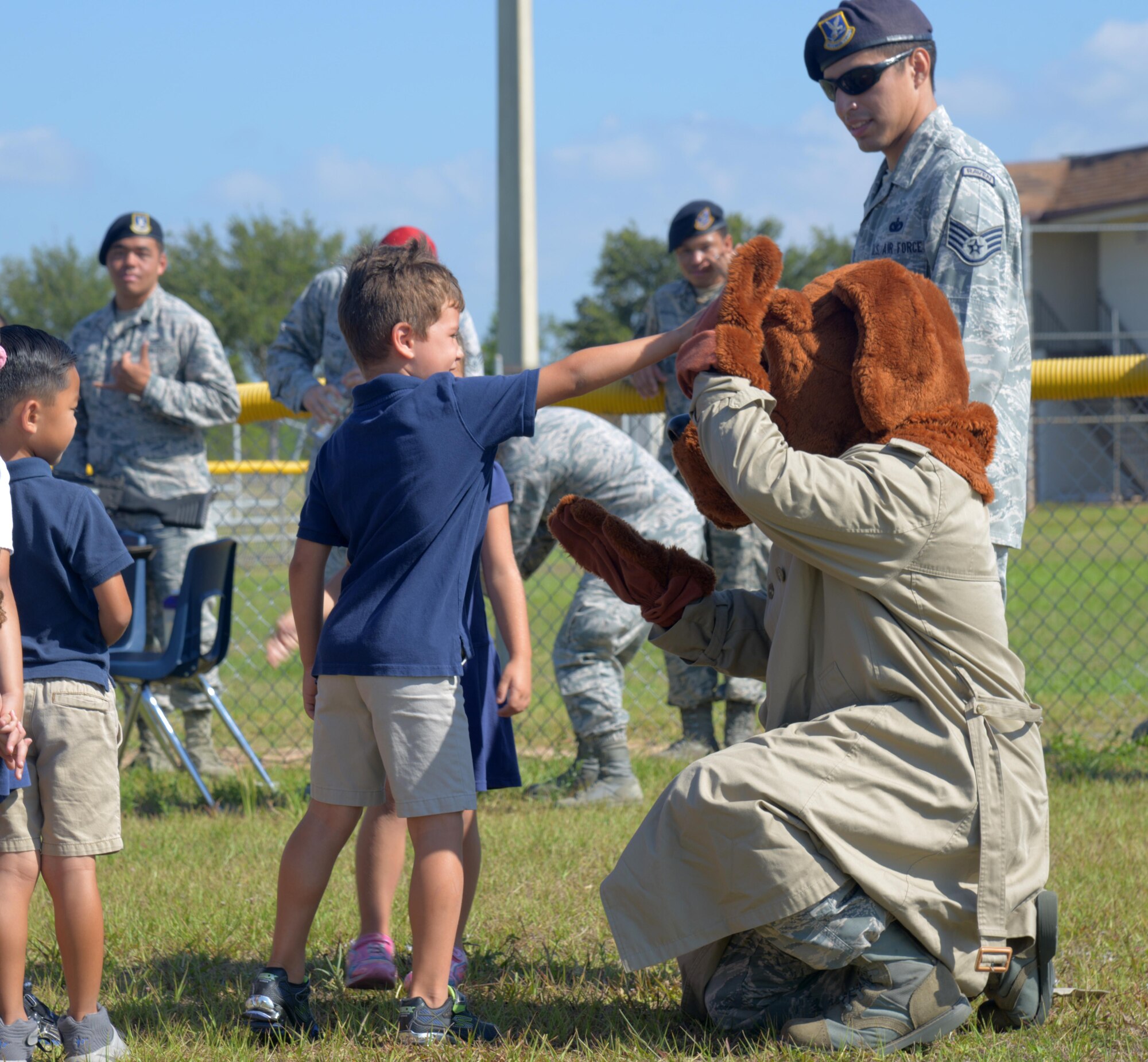 McGruff the Crime Dog gives a high-five to a Tinker Elementary School student at MacDill Air Force Base, Fla., May 16, 2017. The 6th Security Forces Squadron setup different police displays for the students and taught weapon safety in honor of National Police Week. (U.S. Air Force photo by Senior Airman Tori Long)