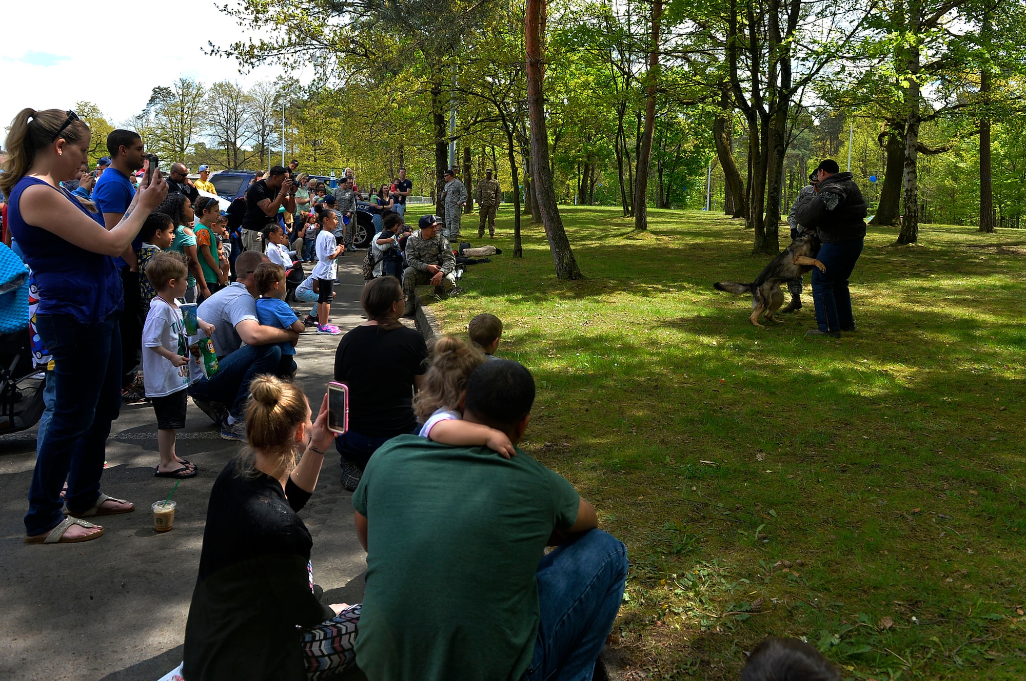 Spectators watch a K-9 demonstration on Ramstein Air Base, Germany, May 13, 2017. Ramstein hosted a family-friendly police display in order to foster trust and support within the community. (U.S. Air Force photo by Airman 1st Class Joshua Magbanua) 