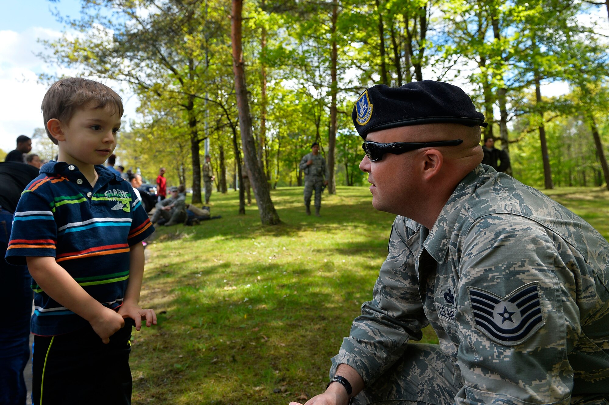 Tech. Sgt. Lance Oakes, 86th Security Forces Squadron military working dog trainer, answers a child’s questions during a Police Week event on Ramstein Air Base, Germany. Ramstein hosted the police display, which involved a variety of exhibits and demonstrations from the Air Force, Army, NATO, and German Polizei. (U.S. Air Force photo by Airman 1st Class Joshua Magbanua)