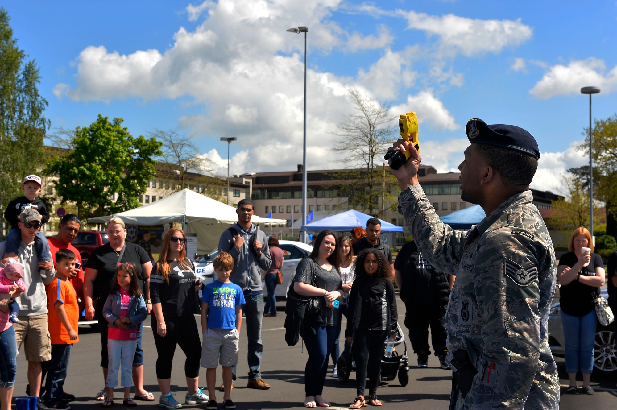 Staff Sgt. Stephen Peterson, 86th Security Forces Squadron base defense operations center controller, demonstrates the functions of a taser during a community building event on Ramstein Air Base, Germany, May 13, 2017. The Police Week display involved participation from police members from the Air Force, Army, NATO, and German Polizei. (U.S. Air Force photo by Airman 1st Class Joshua Magbanua)
