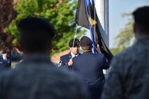 Master Sgt. Loren Mount, flight sergeant, and Tech. Sgt. Wesley Whitaker, fire team leader, both with the 910th Security Forces Squadron (SFS), raise a police memorial flag to half-mast outside the headquarters building here, while SFS members stand in formation at attention May 17, 2017. SFS held a ceremony with representatives from local law enforcement agencies in recognition of Police Week. The ceremony honored the selfless service of U.S. police officers who have fallen in the line of duty. (U.S. Air Force photo/Eric White)