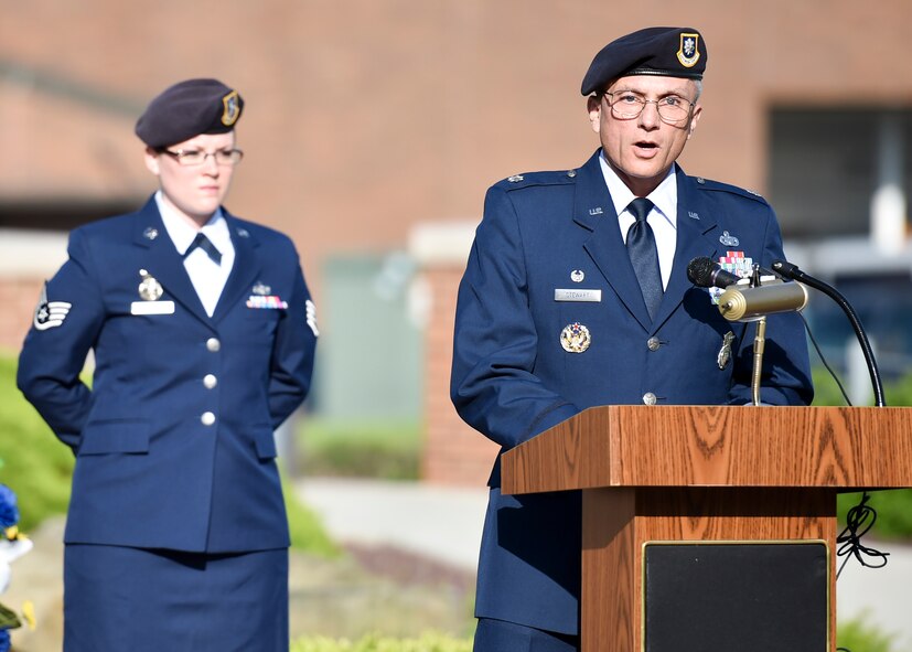 Lt. Col. Scott Stewart, 910th Security Forces Squadron commander, reads a proclamation during a Police Week ceremony here, May 17, 2017.  Staff Sgt. Emily Uhlir, 910th SFS fire team member, stands behind Stewart. Uhlir narrated the ceremony, which SFS held along with representatives from local law enforcement agencies. The ceremony honored the selfless service of U.S. police officers who have fallen in the line of duty. (U.S. Air Force photo/Eric White)
