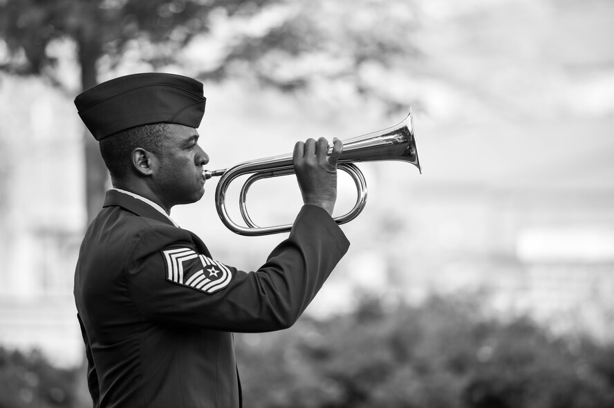 Chief Master Sgt. Shawn White, representing the 910th Airlift Wing Color Guard and Honor Guard, signals taps during a Police Week ceremony here, May 17, 2017. SFS held the ceremony with representatives from local law enforcement agencies to honor police officers who have given their lives in the line of duty. (U.S. Air Force photo/Eric White)