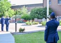 Chief Master Sgt. Shawn White, representing the 910th Airlift Wing Color Guard and Honor Guard, signals taps during a Police Week ceremony here, May 17, 2017, while 910th Security Forces Squadron members and local law enforcement agency officers salute. SFS held the ceremony in recognition of Police Week to honor police officers who have given their lives in the line of duty. (U.S. Air Force photo/Eric White)