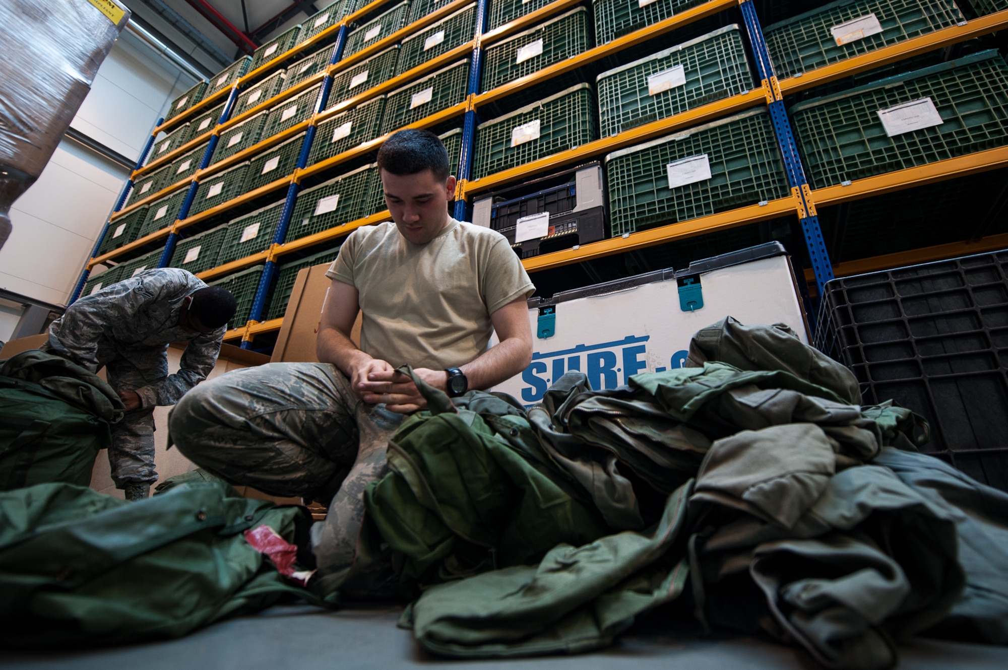 Airman Austin Smith, 86th Logistics Readiness Squadron fuels journeyman, right, and Airman 1st Class Adam Evans III, 86th LRS individual protective equipment journeyman, inventory equipment at the IPE warehouse on Ramstein Air Base, Germany, May 19, 2017. IPE is responsible for maintaining equipment that is used to protect Airmen from chemical, biological, radiological, nuclear and explosive materials. (U.S. Air Force photo by Senior Airman Devin Boyer)