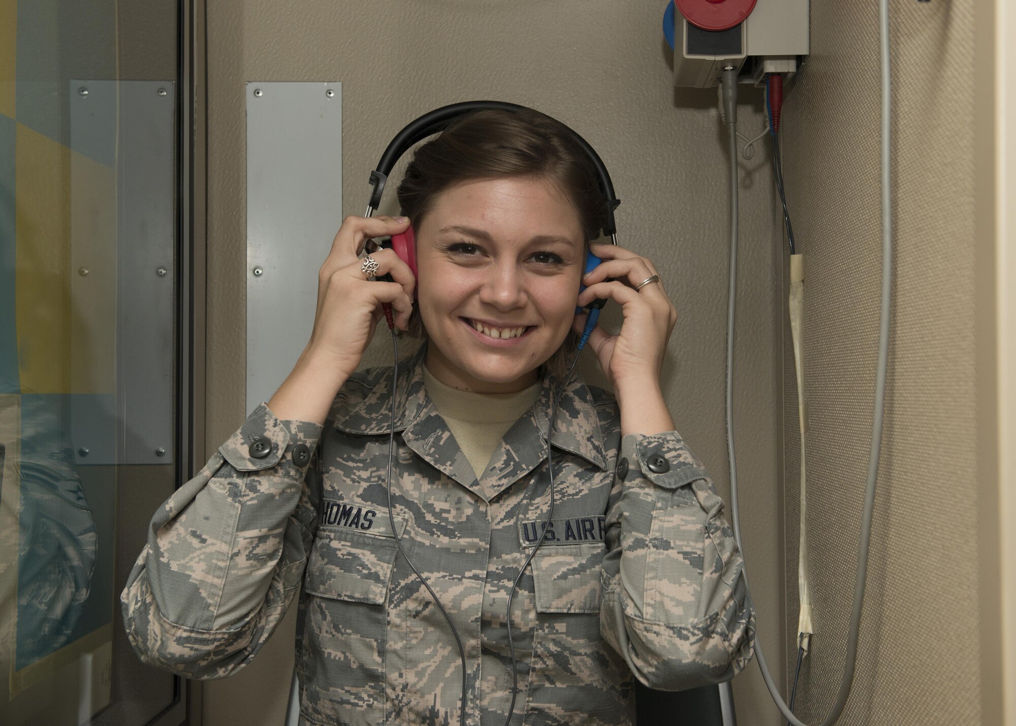 Airman 1st Class Karie Thomas, 436th Aerospace Medicine Squadron public health technician, poses for a photo inside a hearing test booth Nov. 9, 2016, at Dover Air Force Base, Del. Thomas, who grew up a military brat, joined the Air Force to follow in her father’s, grandfather’s and great-grandfather’s footsteps. (U.S. Air Force photo by Senior Airman Zachary Cacicia)