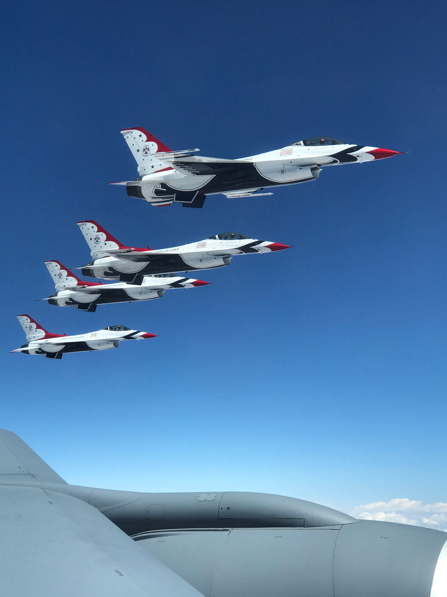 A view of four U.S. Air Force Thunderbirds flanked alongside an Okie KC-135 Stratotanker assigned to the 465th Air Refueling Squadron, 507th Air Refueling Wing, as they await refueling May 18, 2017, on their journey to Tinker Air Force Base for the 2017 Star Spangled Salute Air Show. The air show, scheduled for May 20-21, will commemorate the 75th Anniversary of Tinker AFB. (U.S. Air Force photo/Tech. Sgt. Lauren Gleason)