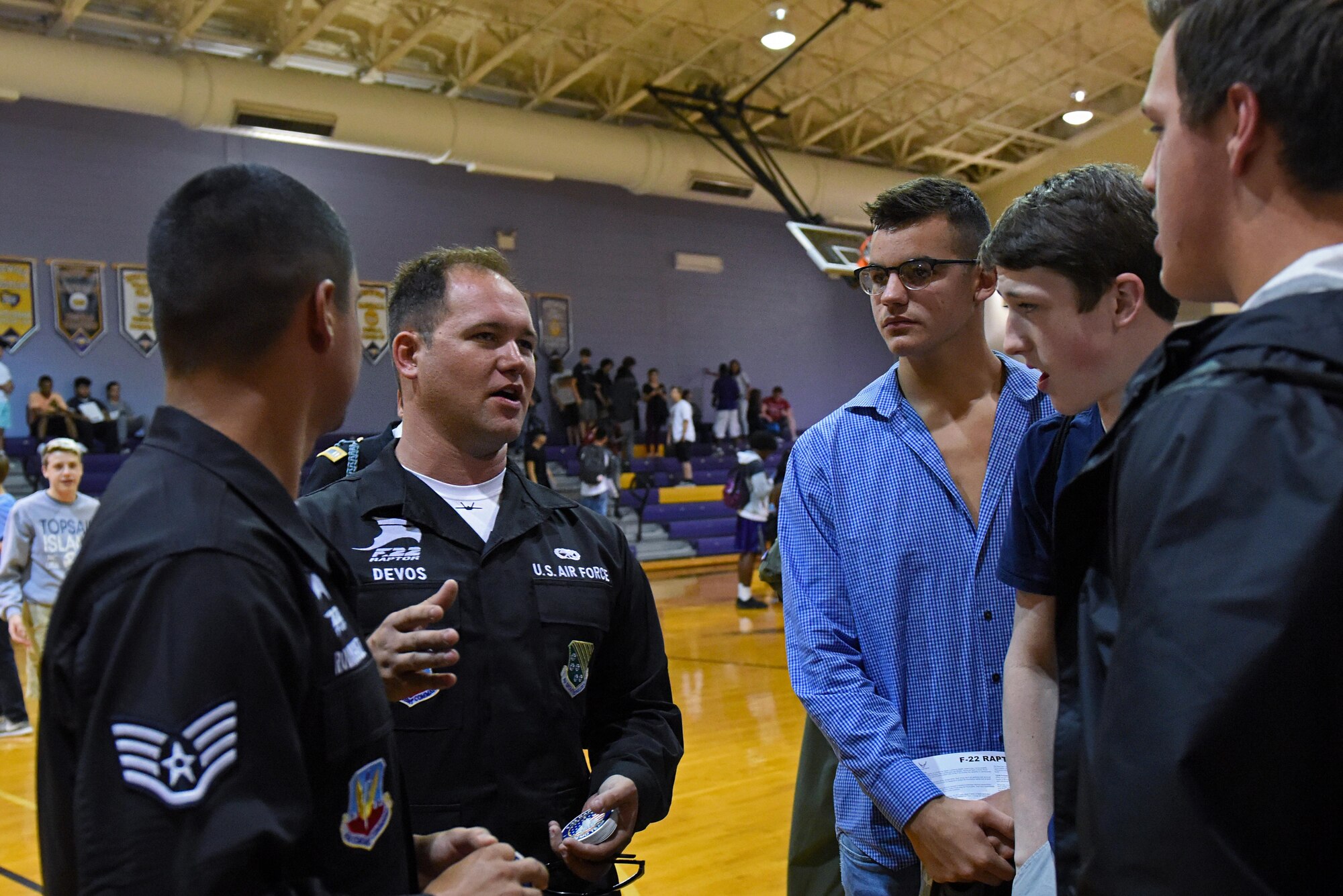 Staff Sgt. Robert Rodriguez (left) and Senior Airman Jack Devos (center left) of the U.S. Air Force F-22 Raptor Demo Team speak with Rosewood High School students, May 18, 2017, at Rosewood High School in Goldsboro, North Carolina. The team visited the school to share stories about their Air Force experience and teach the students about the F-22 Raptor. (U.S. Air Force photo by Senior Airman Ashley Maldonado)