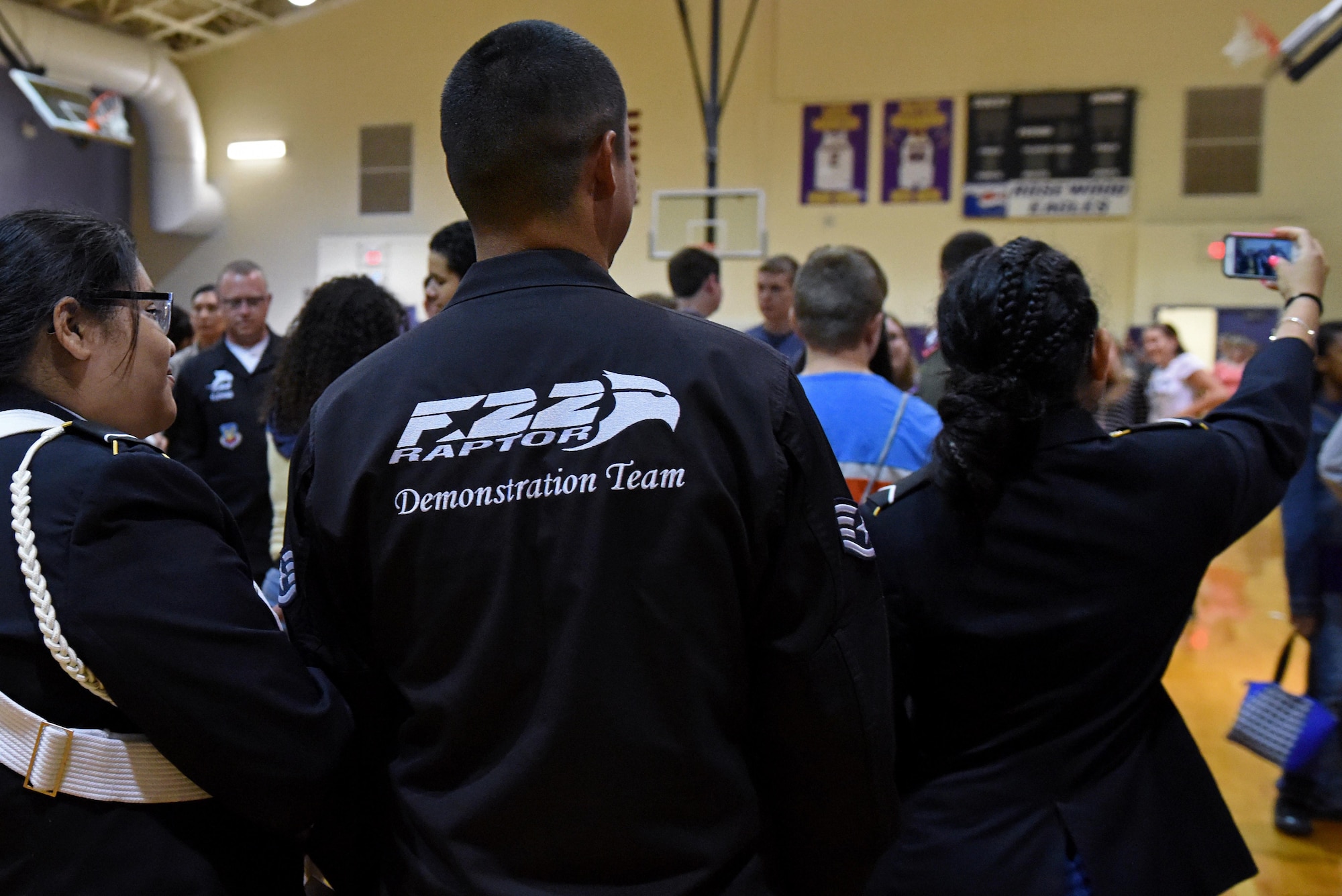 Staff Sgt. Robert Rodriguez of the U.S. Air Force F-22 Raptor Demo Team takes a selfie with students, May 18, 2017, at Rosewood High School in Goldsboro, North Carolina. Members of the team mingled with the students to answer questions and take photos after briefing about the Air Force and F-22 Raptor. (U.S. Air Force photo by Senior Airman Ashley Maldonado)