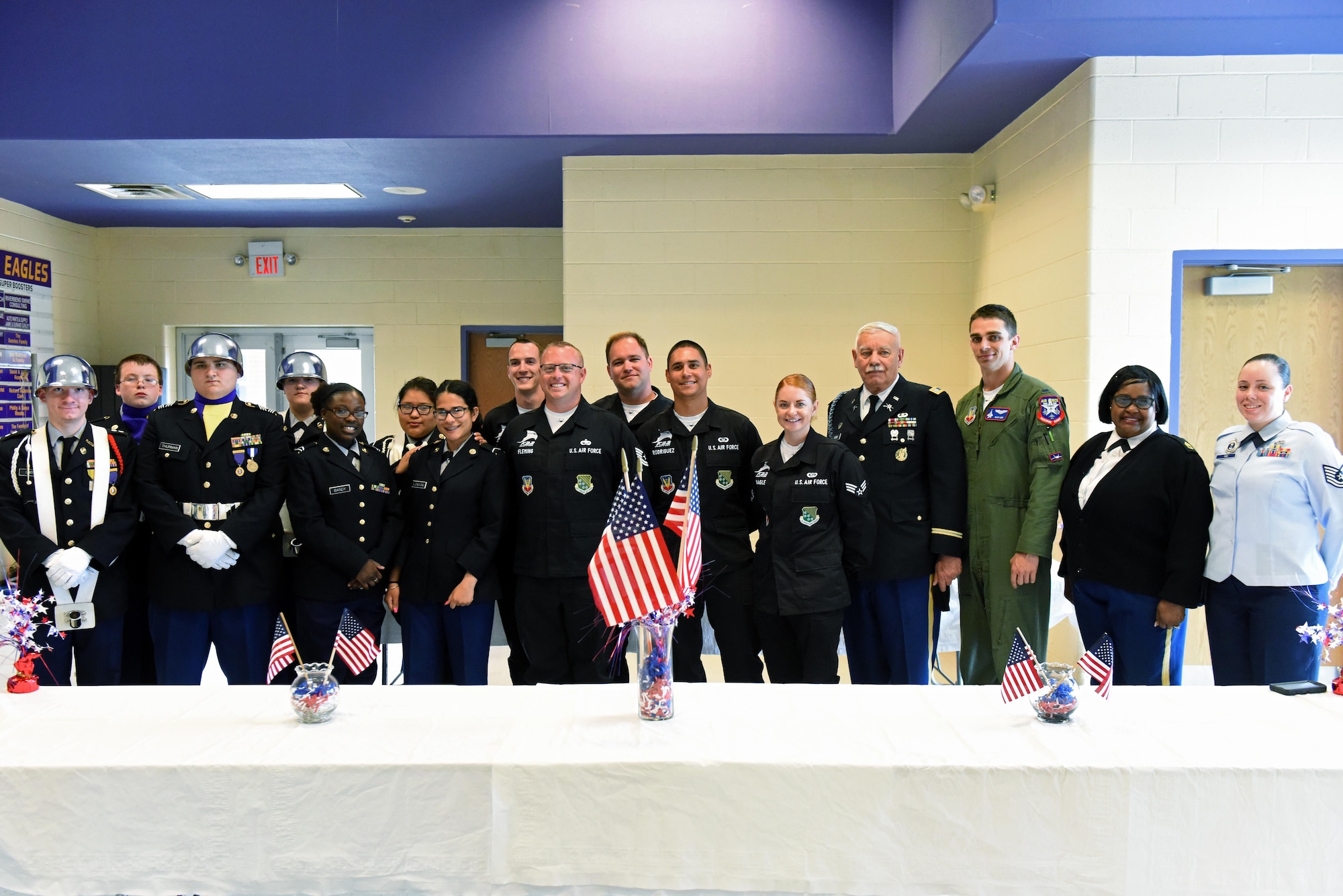 The U.S. Air Force F-22 Raptor Demo Team poses for a group photo with Rosewood High School’s Junior Reserve Officers' Training Corps cadets, May 18, 2017, at Rosewood High School in Goldsboro, North Carolina. The demo team answered questions and shared advice about the military with the cadets. (U.S. Air Force photo by Senior Airman Ashley Maldonado)